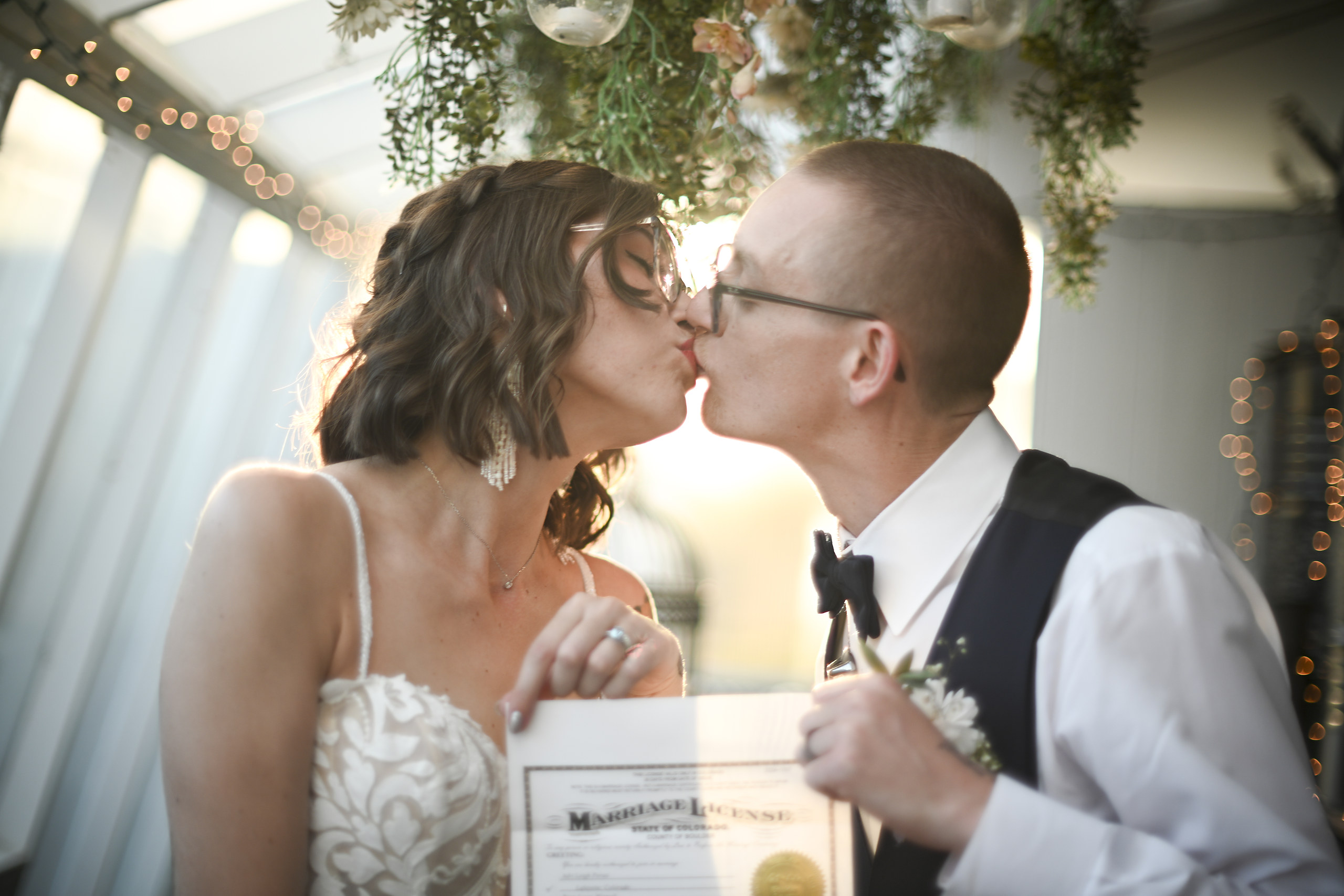 Newlyweds kissing during an autumn wedding ceremony in Colorado